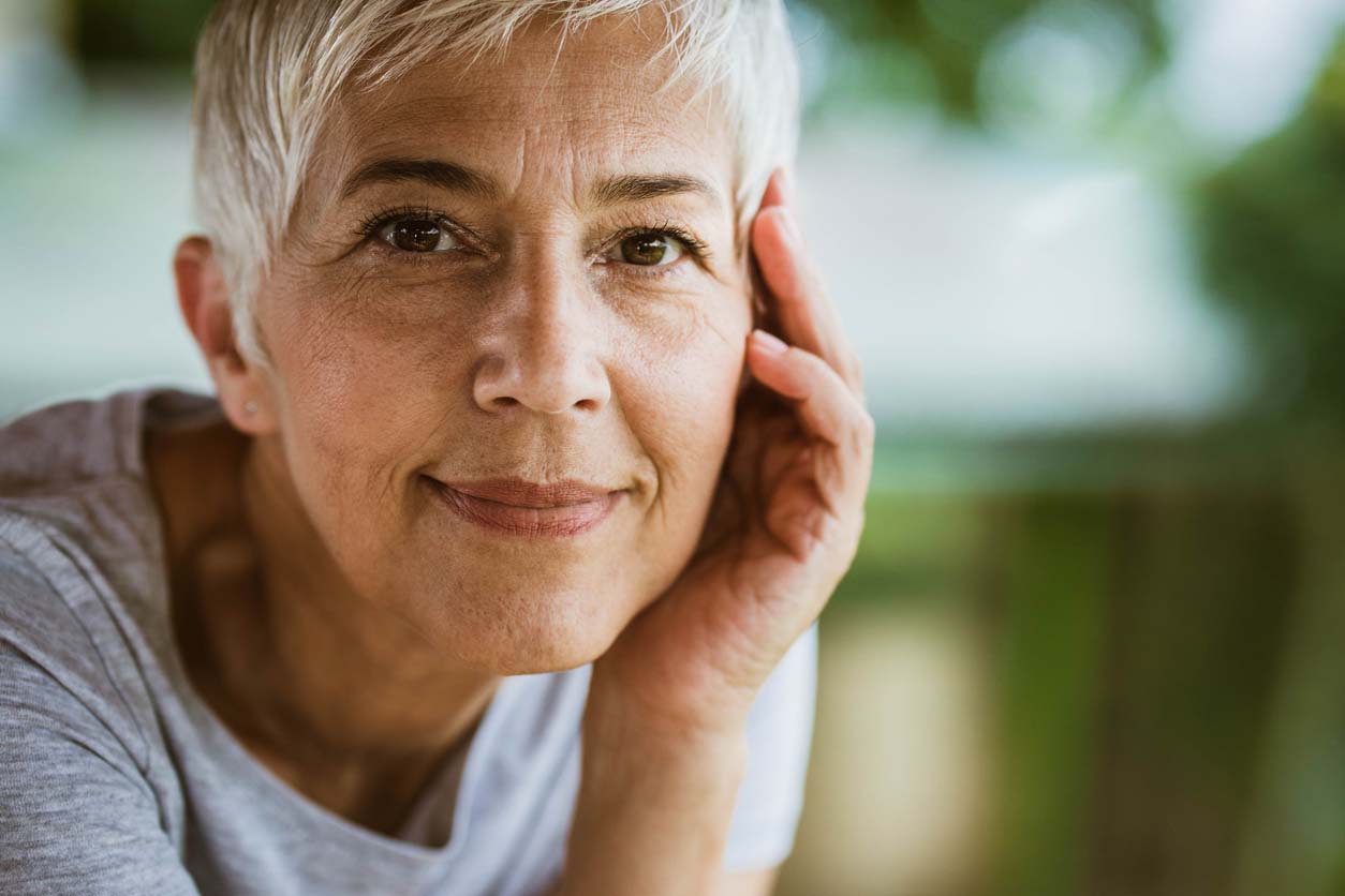 older woman smiling with natural wrinkles