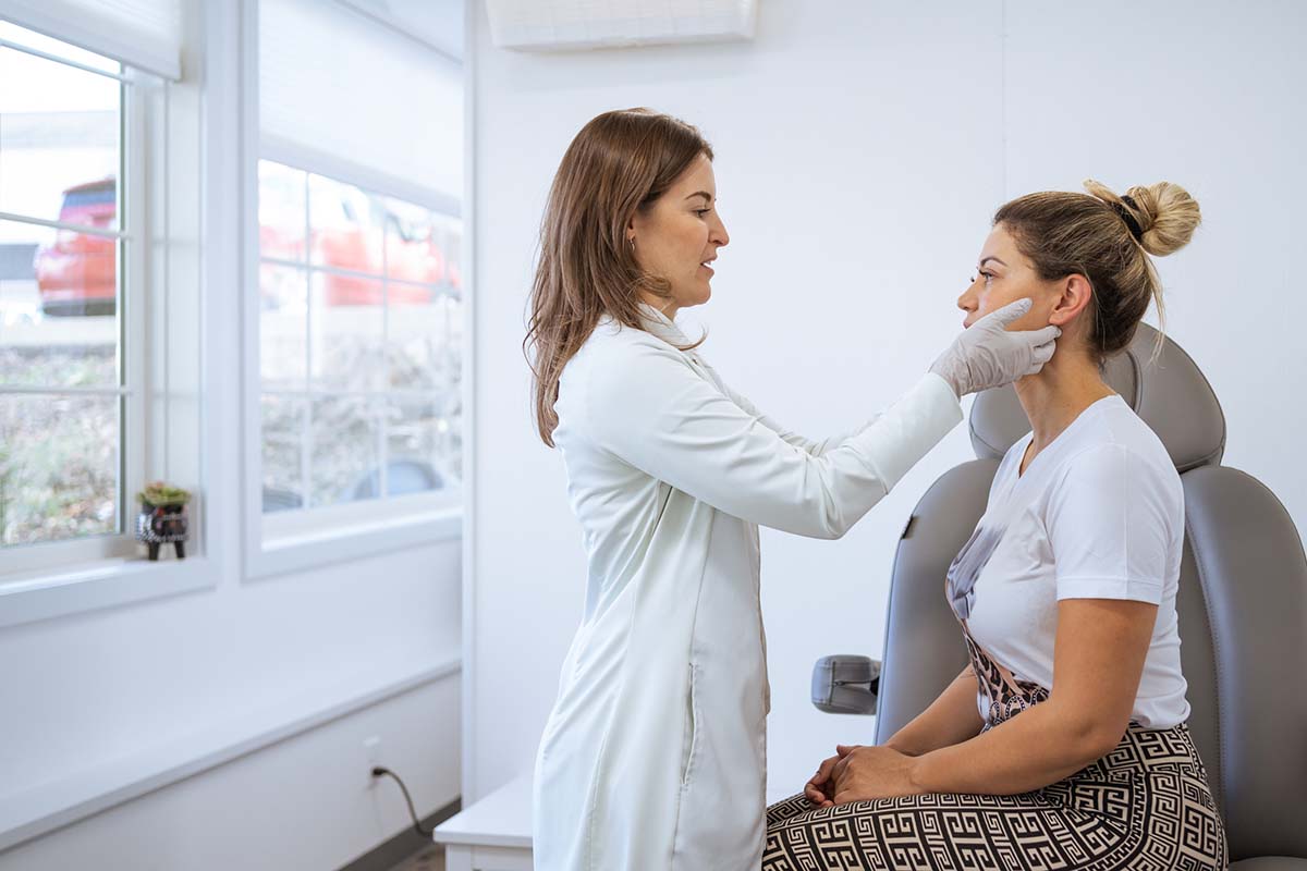 a patient and dermatologist during an appointment