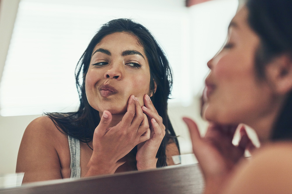 a young woman wondering what type of acne she has